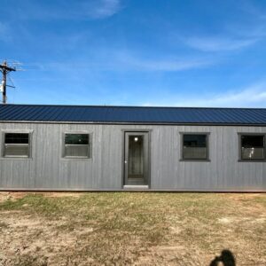Gray 40-foot portable building with wood siding, dark metal roof, four windows, and a centered glass entry door
