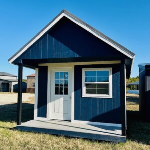 Front exterior view of a blue portable cabin-style shed with covered porch, single entry door, and front window